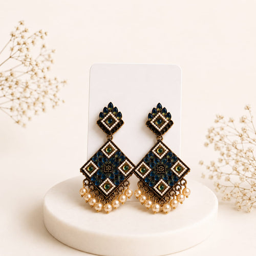 Neelam Kundan diamond dangler earrings on display card