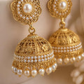 Close up of pearl and gold filigree detail on jhumka earrings