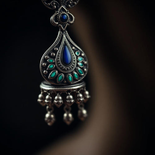 Close-up of peacock enamel detail on oxidized silver jhumka
