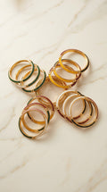 Multicolor gold bangle bundles on ivory marble