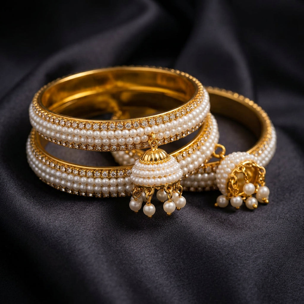 Macro close-up of pearl jhumka bangles on dark silk